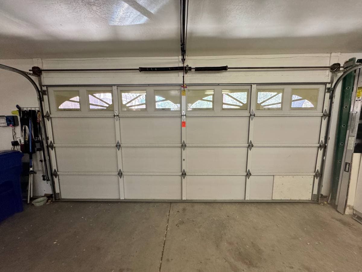 Two-car garage door with decorative windows โ completed installation by Ferch Doors LLC
